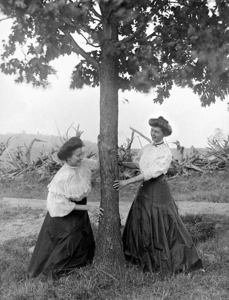 Detail of Two women chase each other around a tree, ca. 1910 by Anonymous