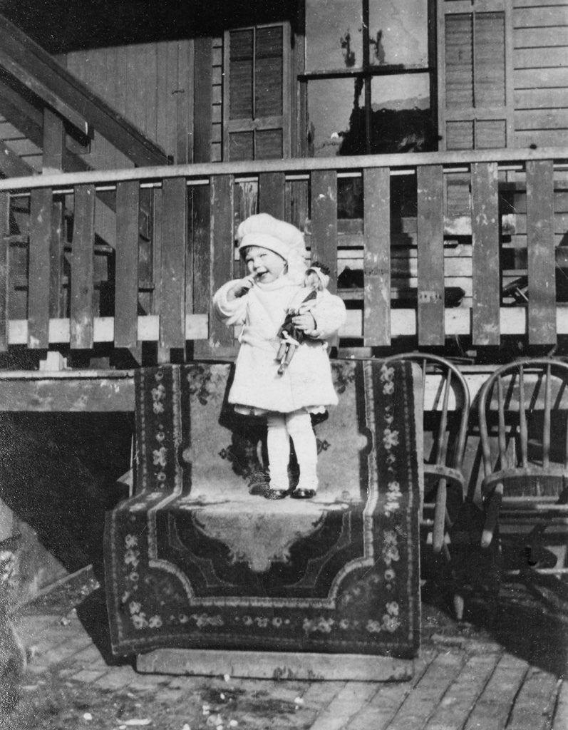 Detail of Young girl outside her house, ca. 1921. by Anonymous