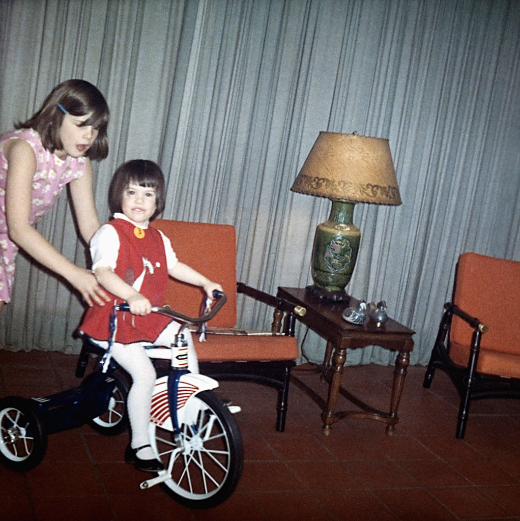 Detail of Older sister helps her sister with new bike, ca. 1967. by Anonymous