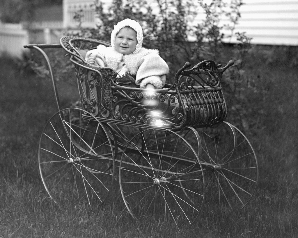 Baby in a baby carriage, ca. 1895. by Corbis