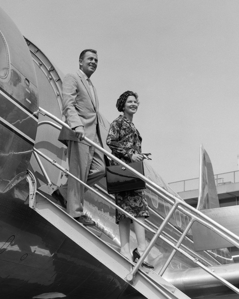 Detail of 1950s couple exiting plane steps by Anonymous