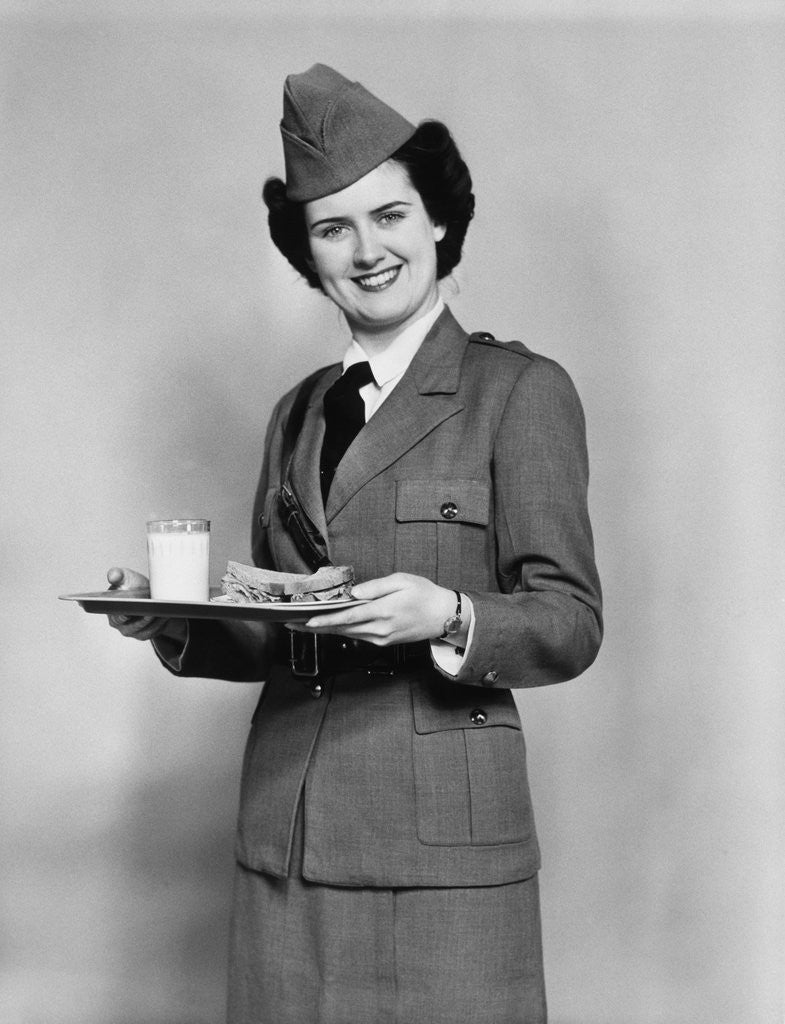 Detail of 1940s army woman with lunch tray with a glass of milk and sandwich by Anonymous