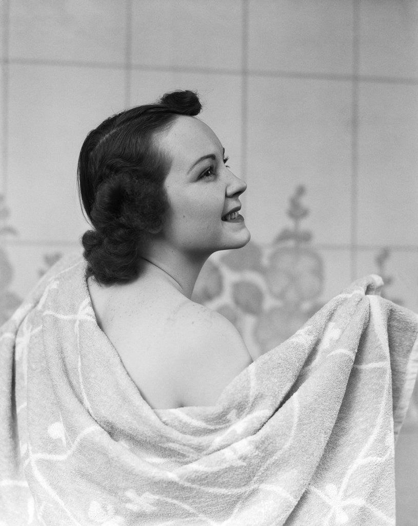 Detail of 1930s brunette woman drying back with towel by Anonymous