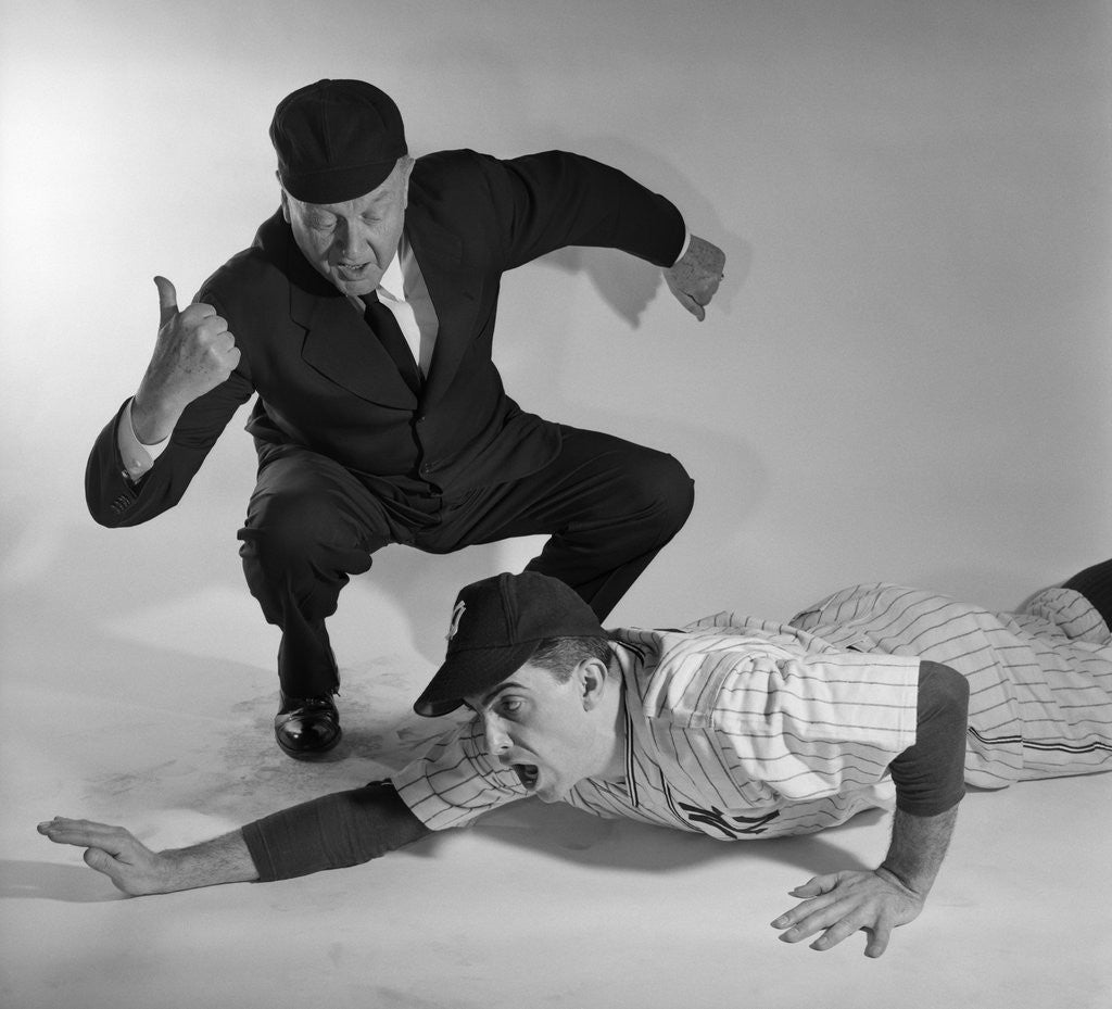 Detail of 1950s baseball umpire calling sliding player out studio shot by Anonymous
