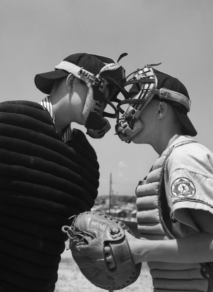 Detail of 1950s boys in baseball uniforms face to face arguing umpire & catcher by Corbis