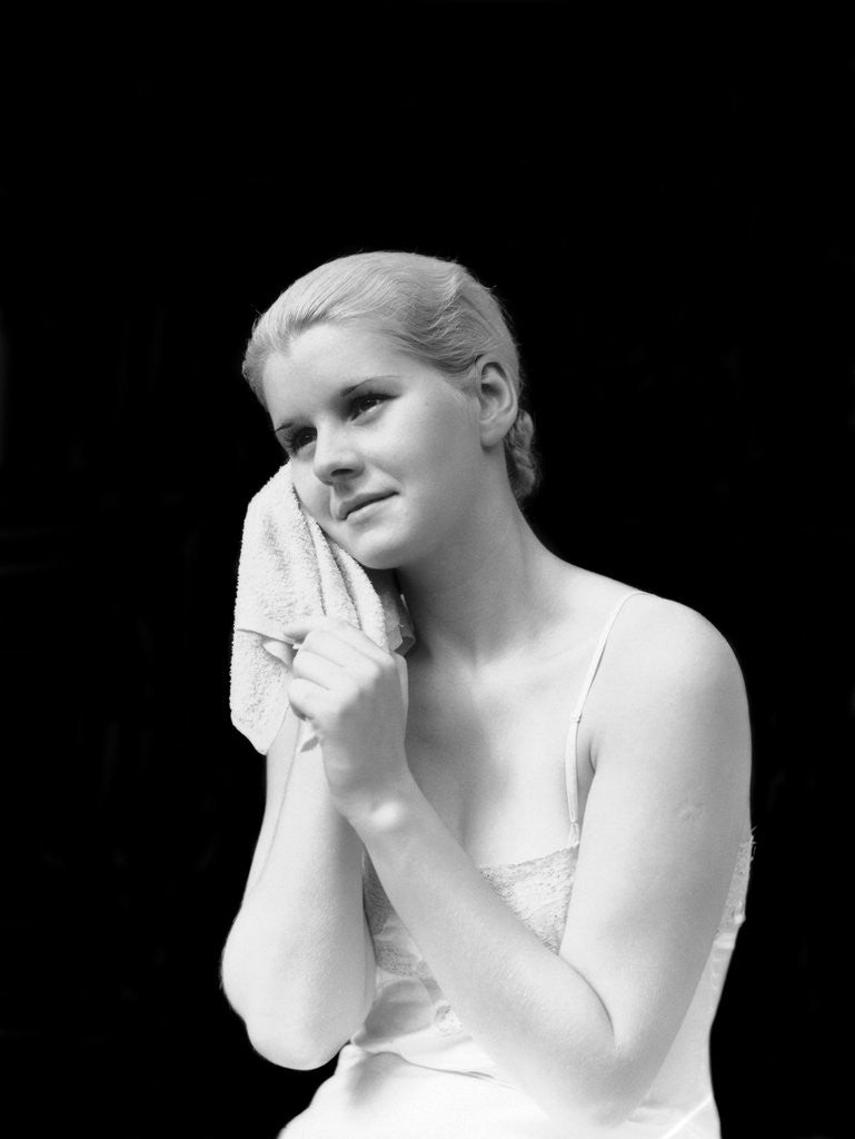 Detail of 1930s blond woman washing face with washcloth towel by Anonymous