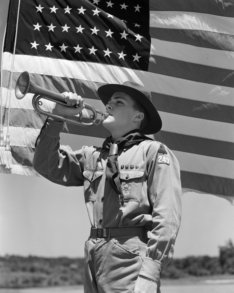 Detail of 1940s boy scout playing bugle in front of 48 star american flag by Anonymous
