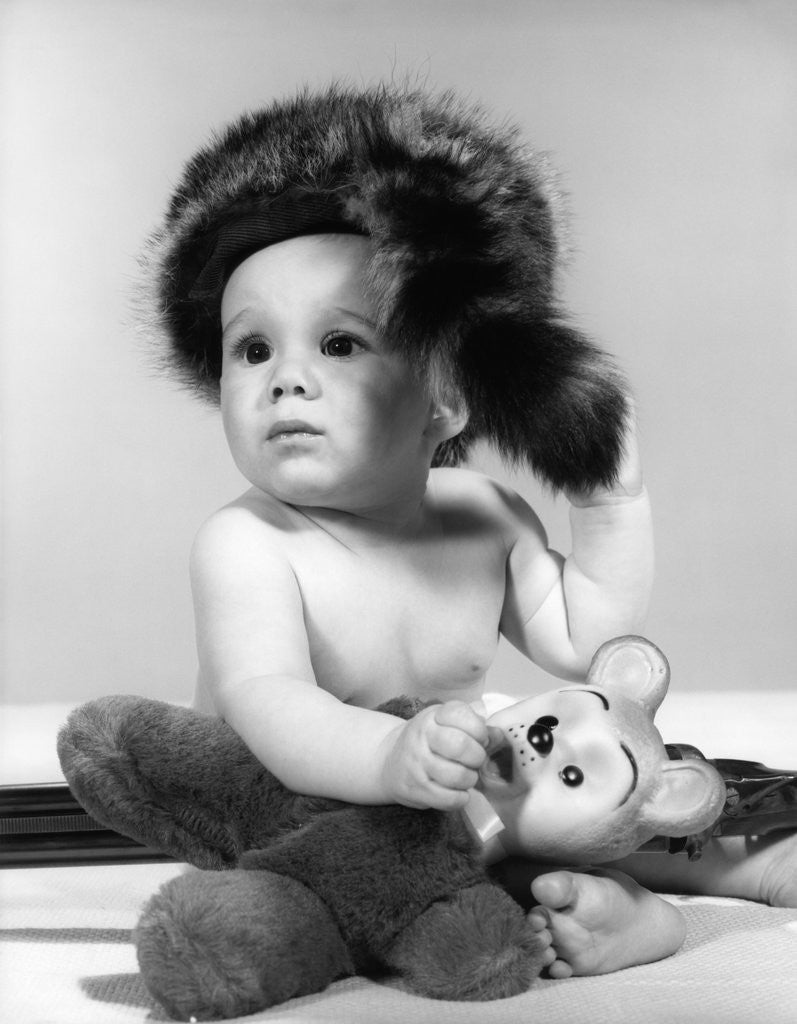 Detail of 1960s baby wearing coonskin hat by Corbis