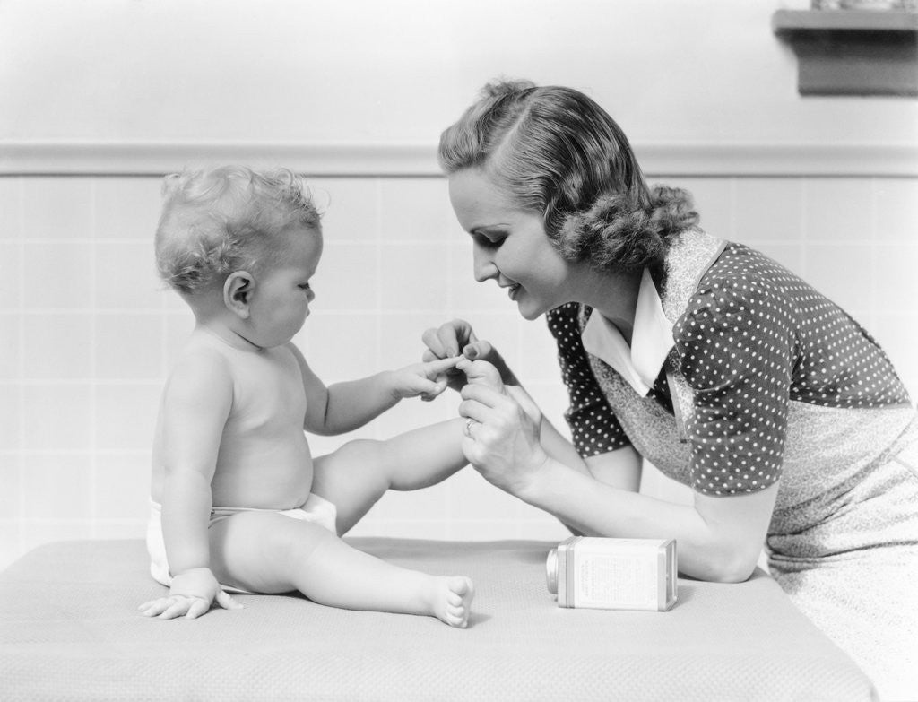 Detail of 1930s mother touching baby toes fingers this little piggy nursery rhyme by Anonymous