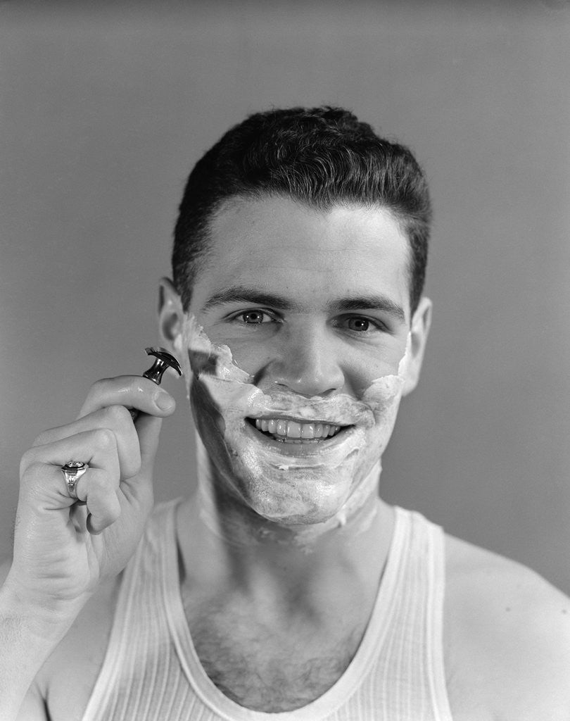 Detail of 1940s smiling man shaving wearing tee shirt by Anonymous