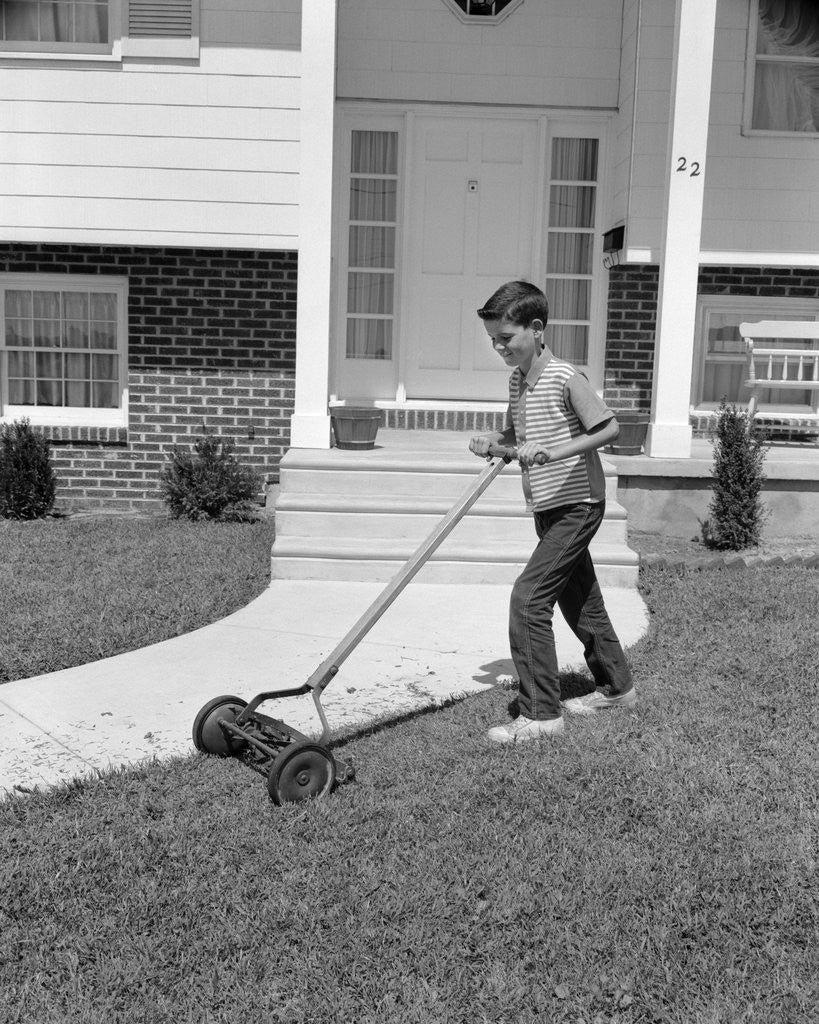 Detail of 1960s boy cutting mowing suburban home front yard lawn by Anonymous