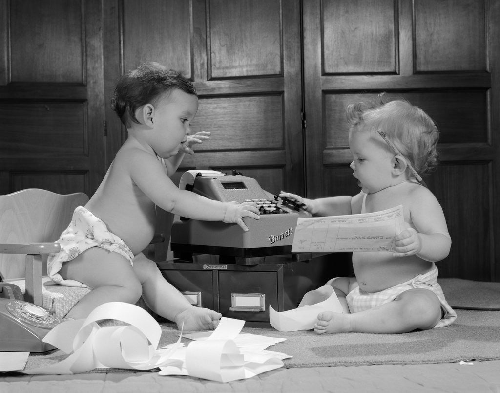 Detail of 1960s two babies wearing diapers in business office with adding machine playing accountant by Anonymous