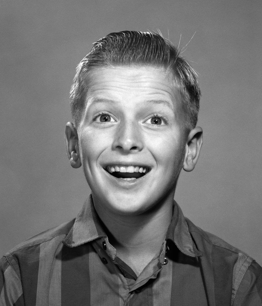 1960s portrait smiling wide-eyed happy surprised teenage boy looking at camera by Corbis