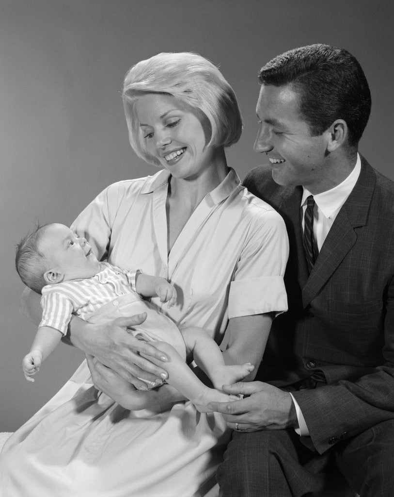 Detail of 1960s happy mother and father smiling at their baby by Anonymous
