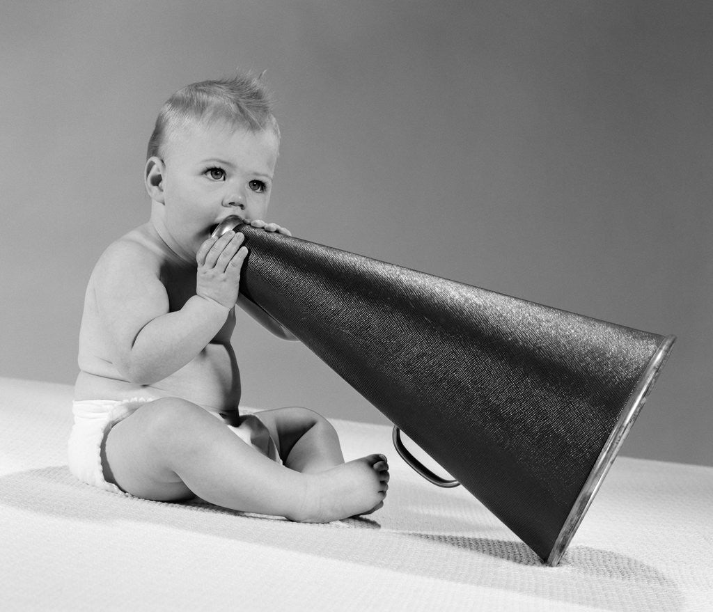 Detail of 1960s baby in diaper seated holding megaphone by Corbis