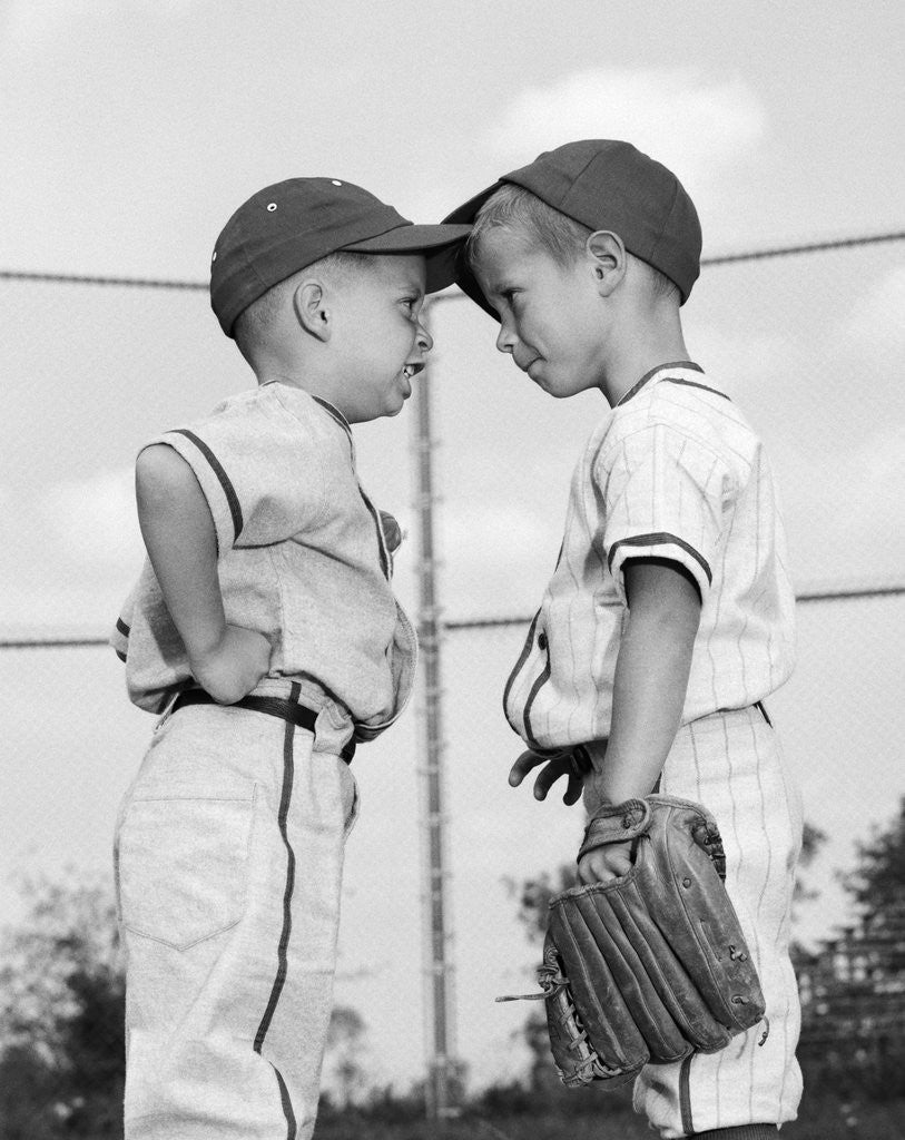 Detail of 1960s two boys playing baseball arguing by Corbis