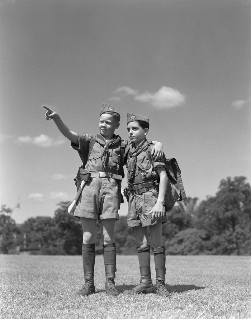 Detail of 1950s two boy scouts one pointing wearing hiking gear uniforms by Corbis