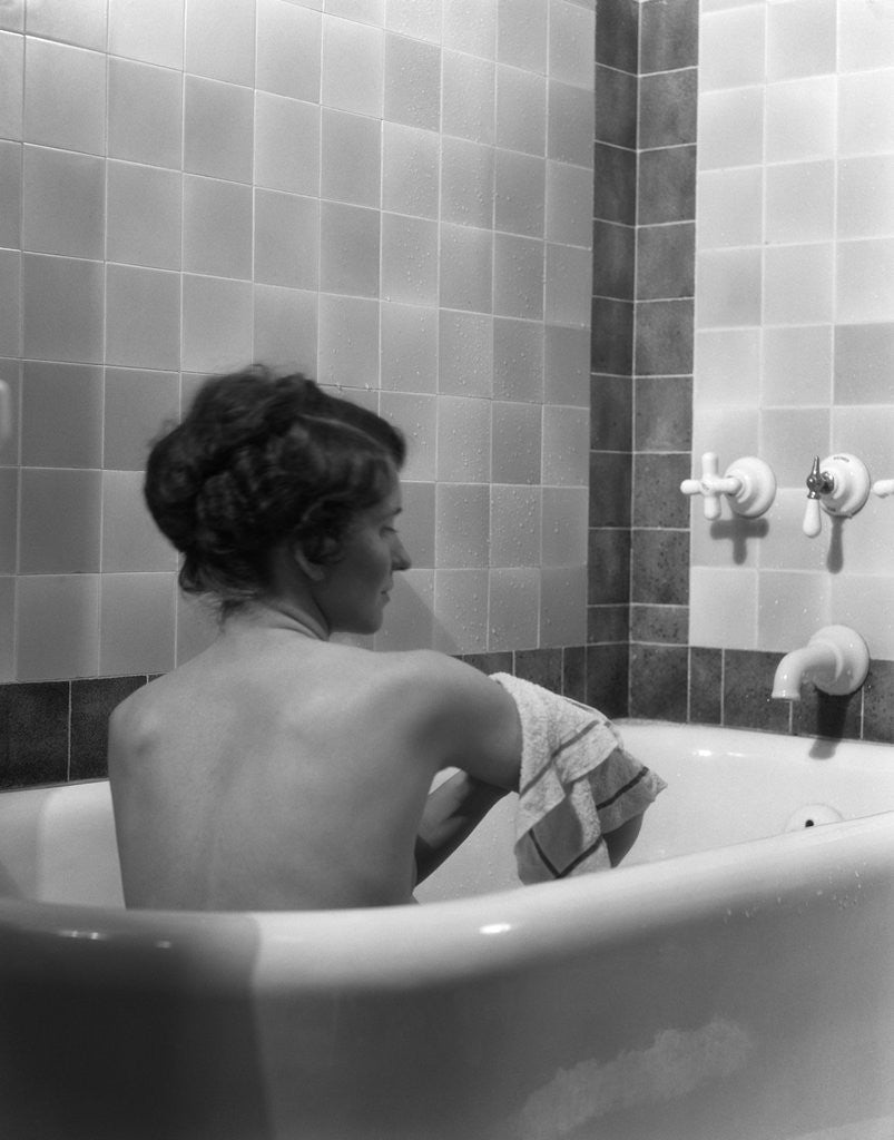 Detail of 1920s 1930s young brunette woman sitting in luxury bathtub taking a bath by Anonymous