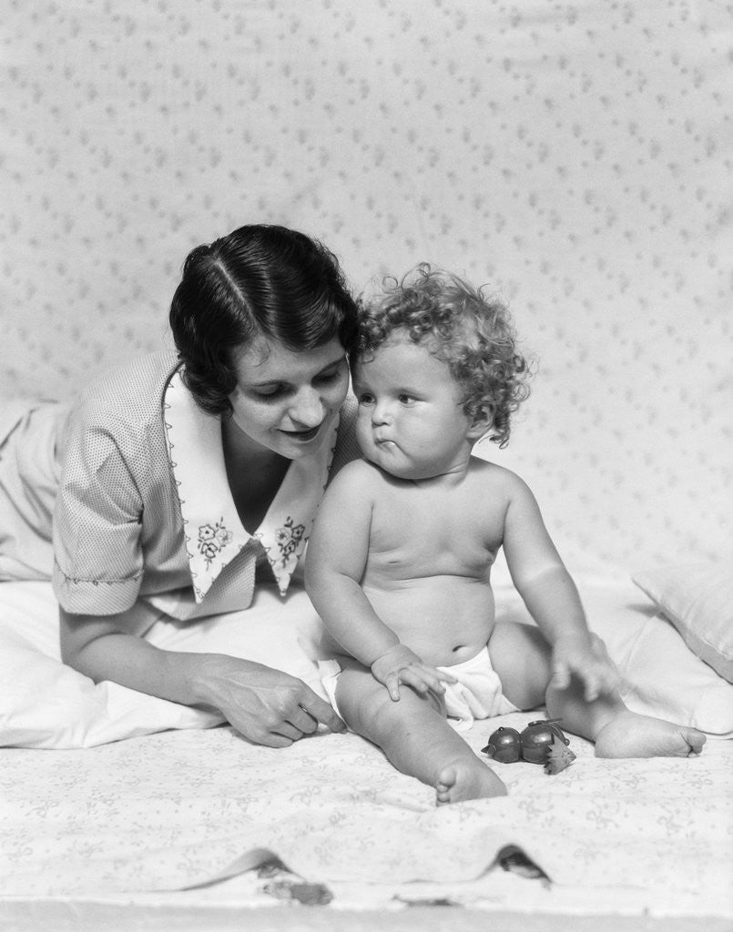 Detail of 1920s 1930s woman mother lying sitting with baby on blanket by Anonymous
