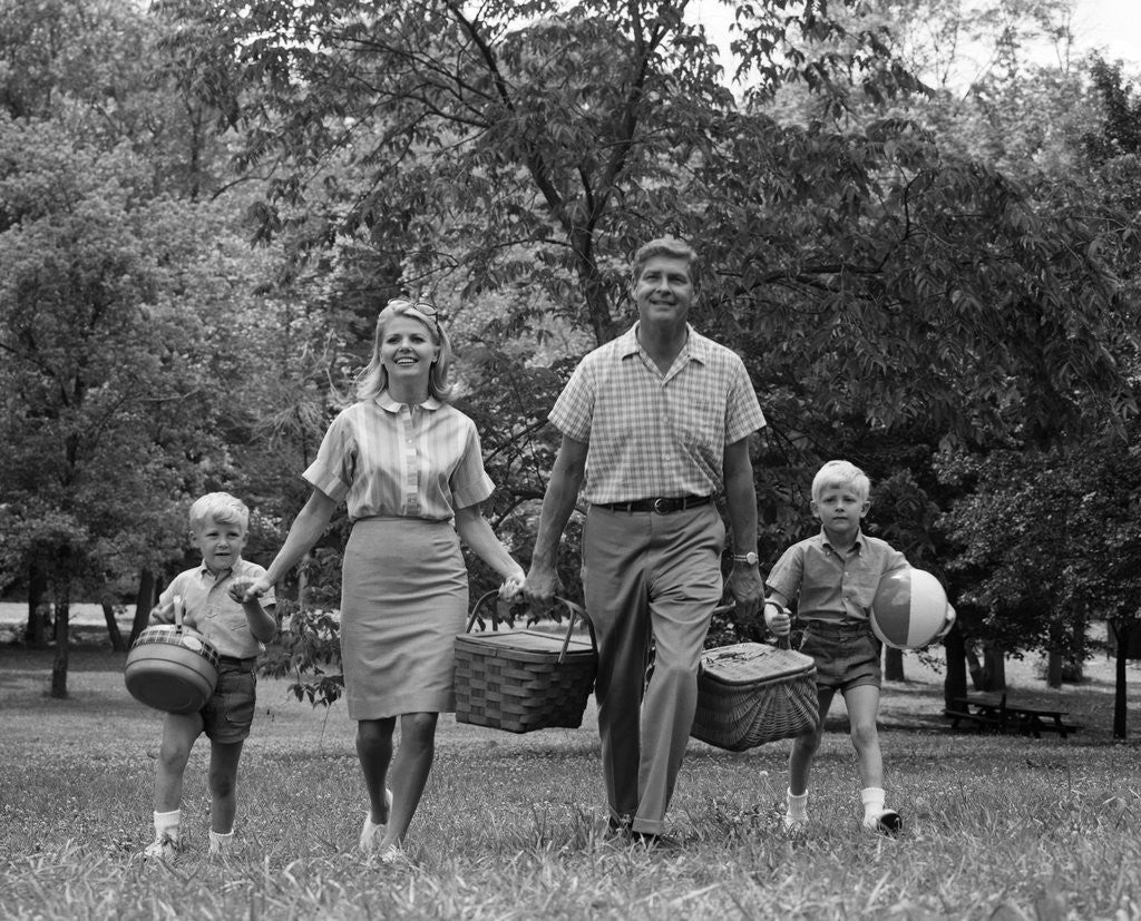 Detail of 1960s family picnic walking toward looking at camera by Anonymous