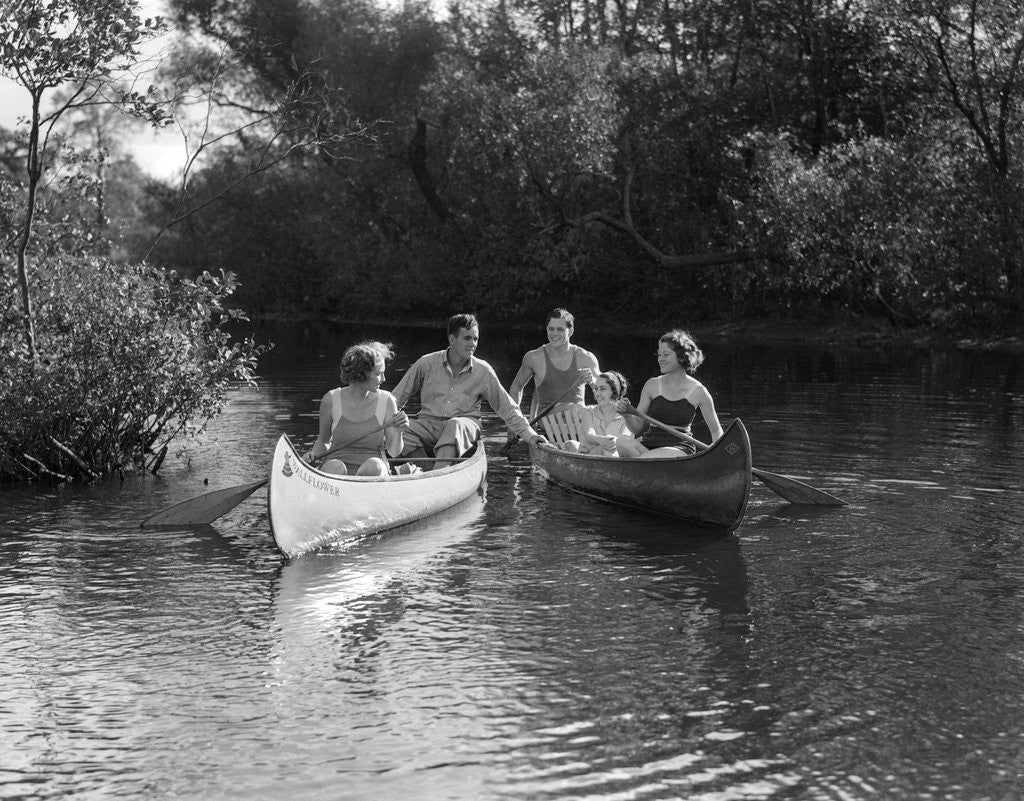 Detail of 1930s summertime group of five young men & women in two canoes paddling down a stream by Anonymous