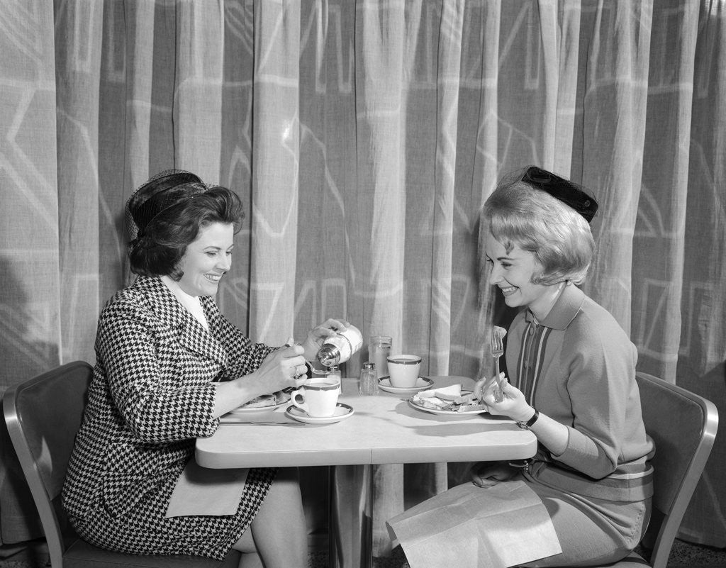 1960s two women having lunch in coffee shop restaurant by Corbis