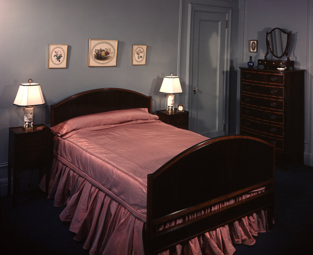 Detail of 1930s 1940s bedroom double bed with pink satin bedspread by Anonymous