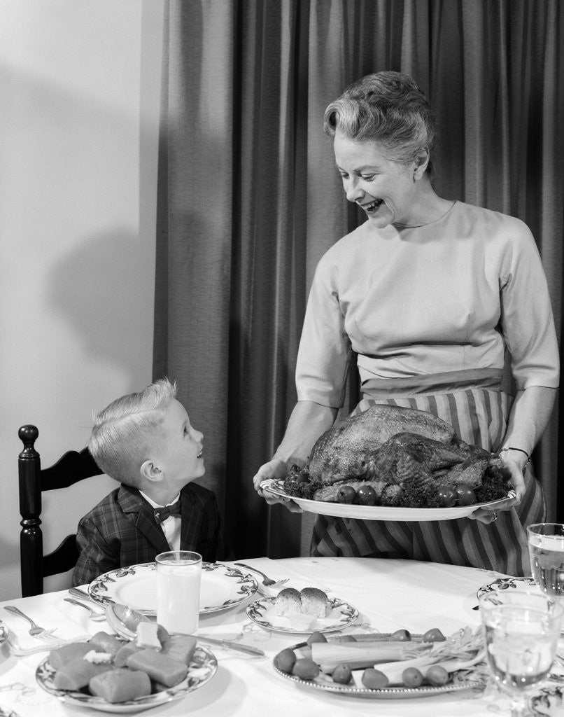 Detail of 1960s grandmother grandson roast turkey thanksgiving dinner by Anonymous