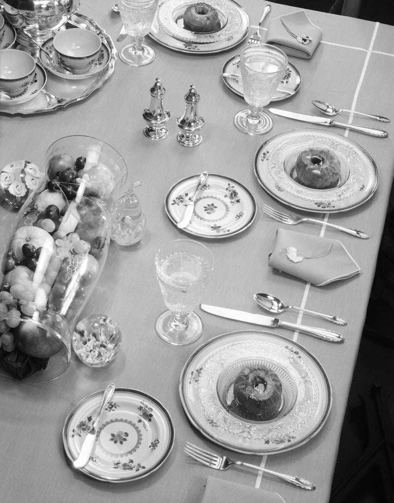 Detail of 1950s table setting centerpiece dinner dessert baked apples & fruit bowl by Anonymous