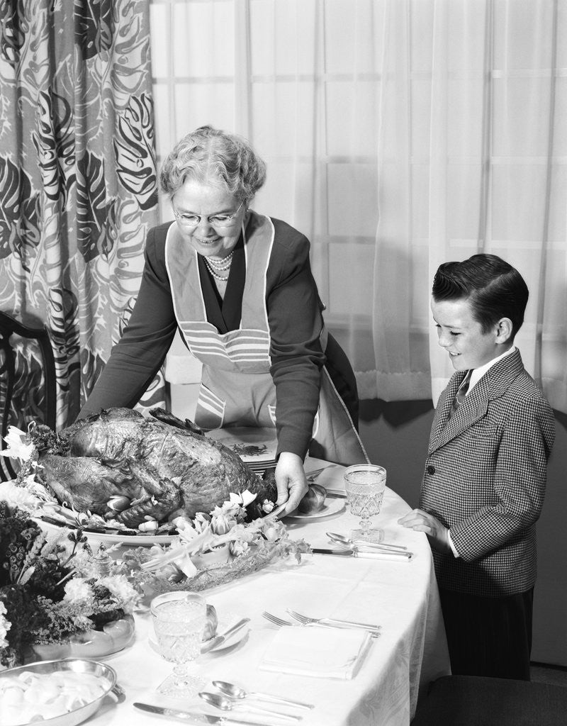 Detail of 1950s grandmother grandson turkey thanksgiving dinner by Anonymous