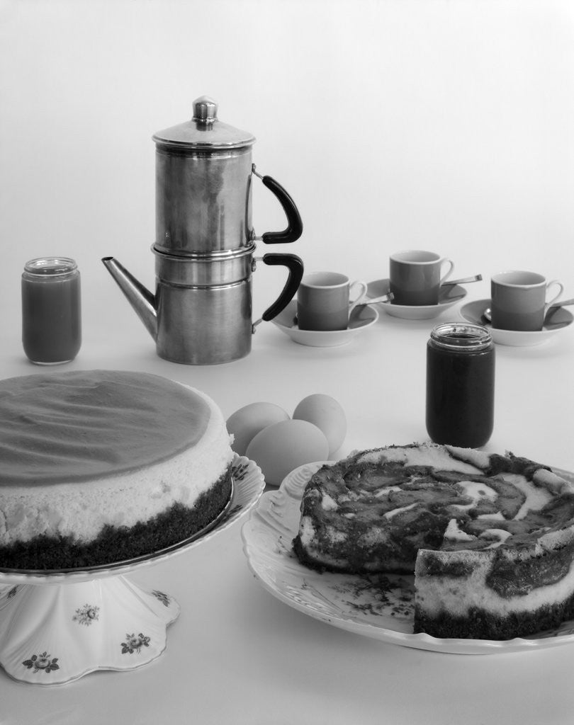 Detail of 1950s coffee pot cups and saucers and two dessert cakes by Corbis