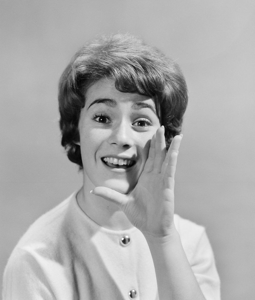 Detail of 1950s woman yelling with hand held up to her face by Corbis