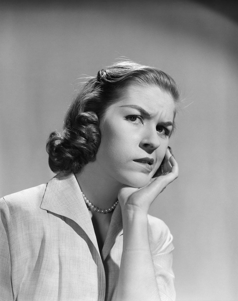 Detail of 1950s 1960s woman portrait worried facial expression hand to cheek tooth pain by Anonymous