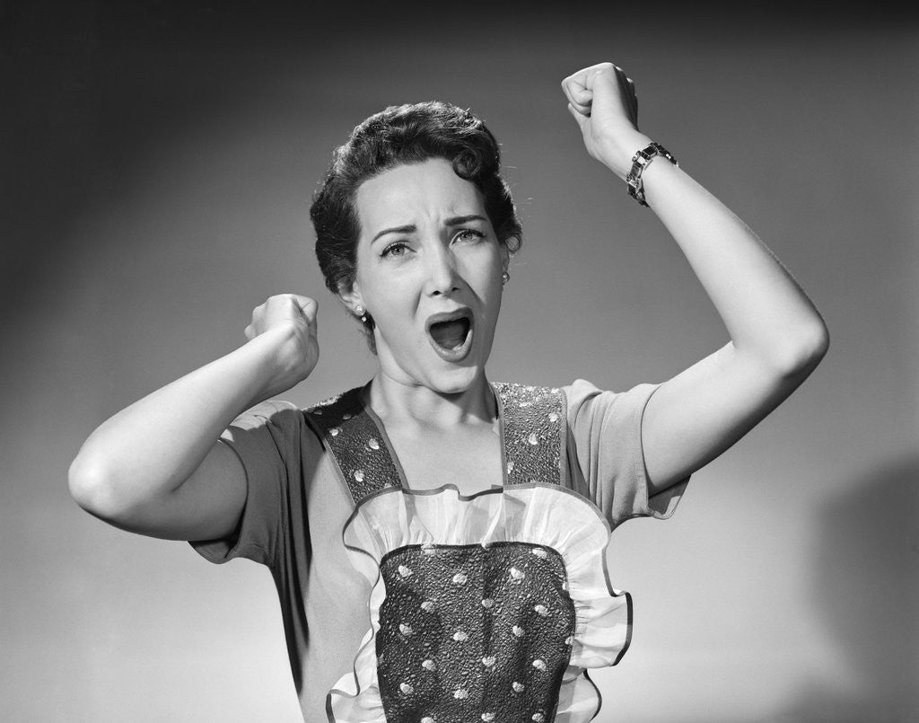 Detail of 1950s woman in apron ruffled edge fists up in air yelling screaming angry housewife by Anonymous