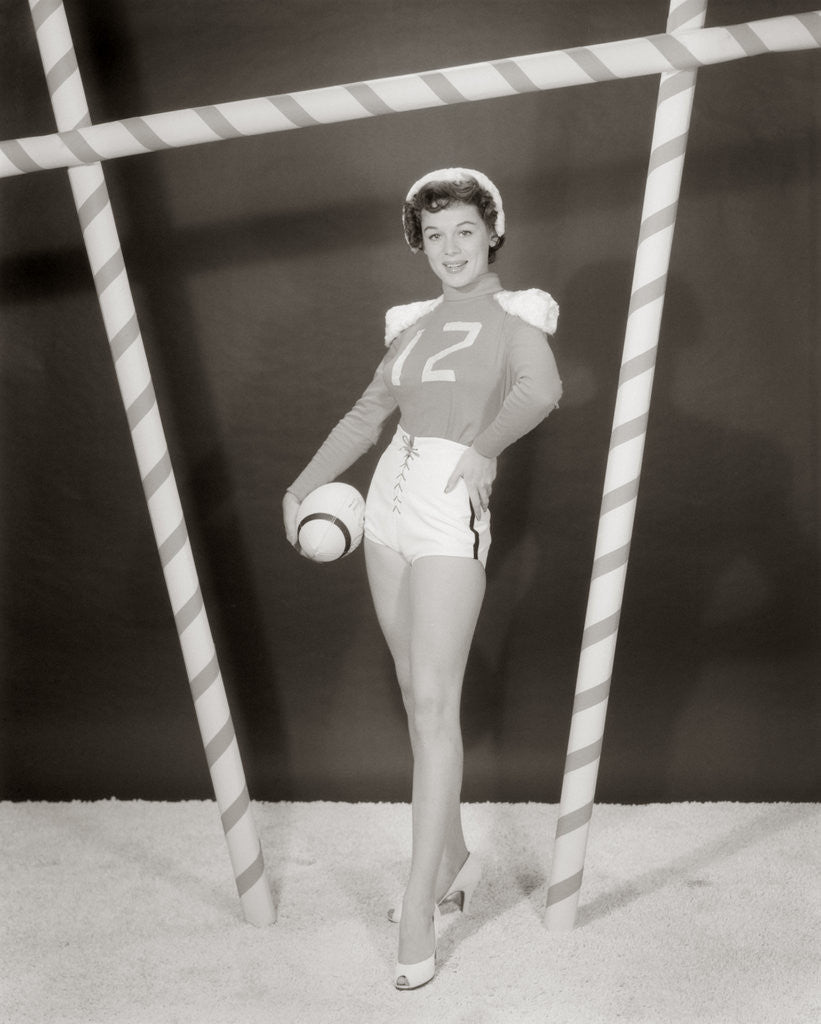 Detail of 1950s 1960s woman in sexy football costume at goalpost by Anonymous