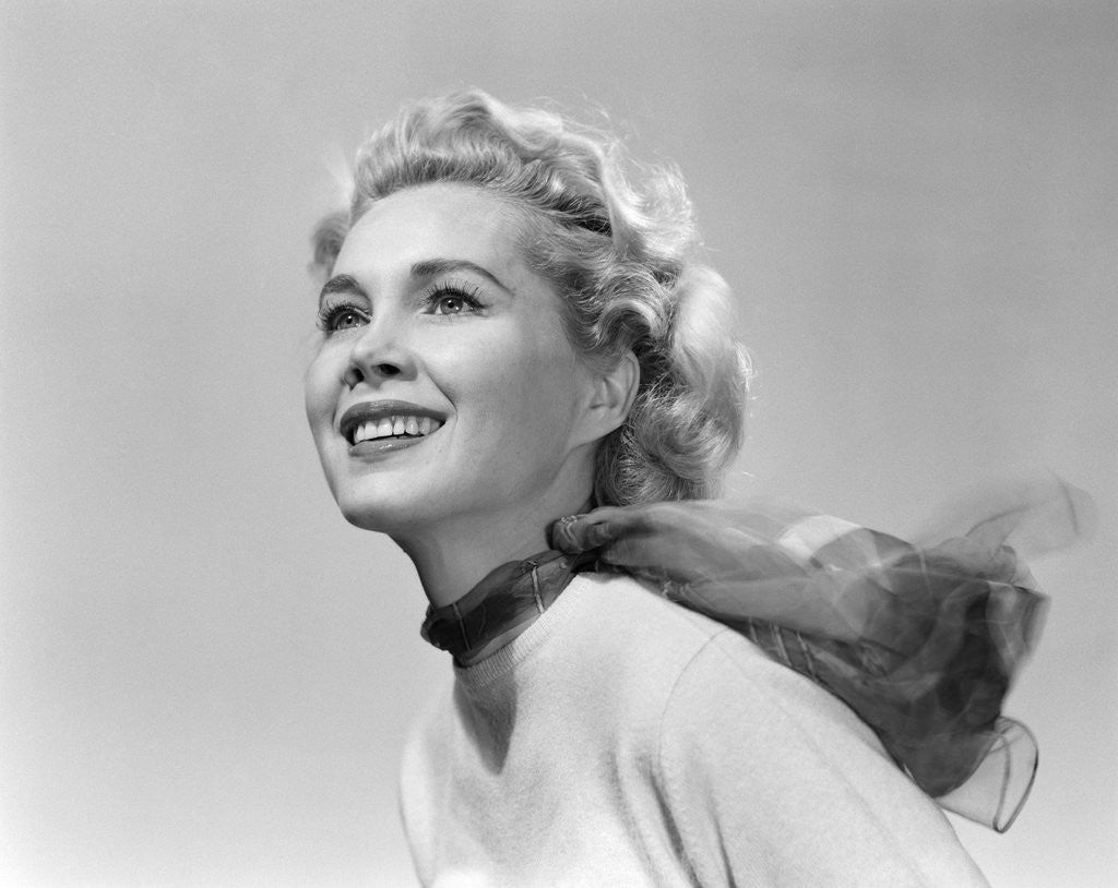 Detail of 1950s 3/4 profile portrait smiling blond woman with wind blown hair and scarf by Anonymous