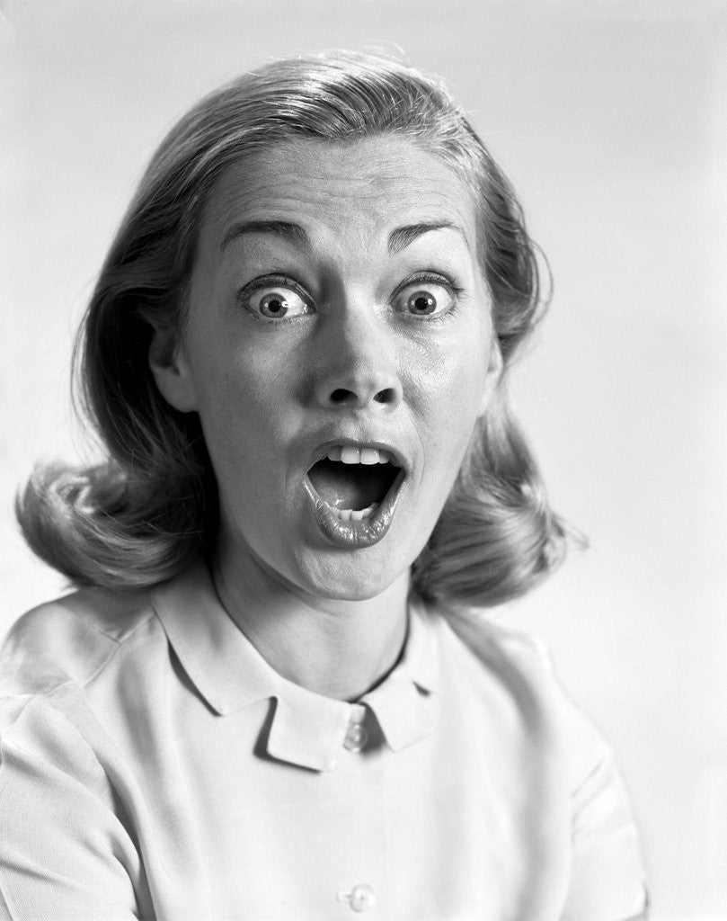 Detail of 1960s head shot woman eyes and mouth wide open terrified expression looking at camera by Anonymous