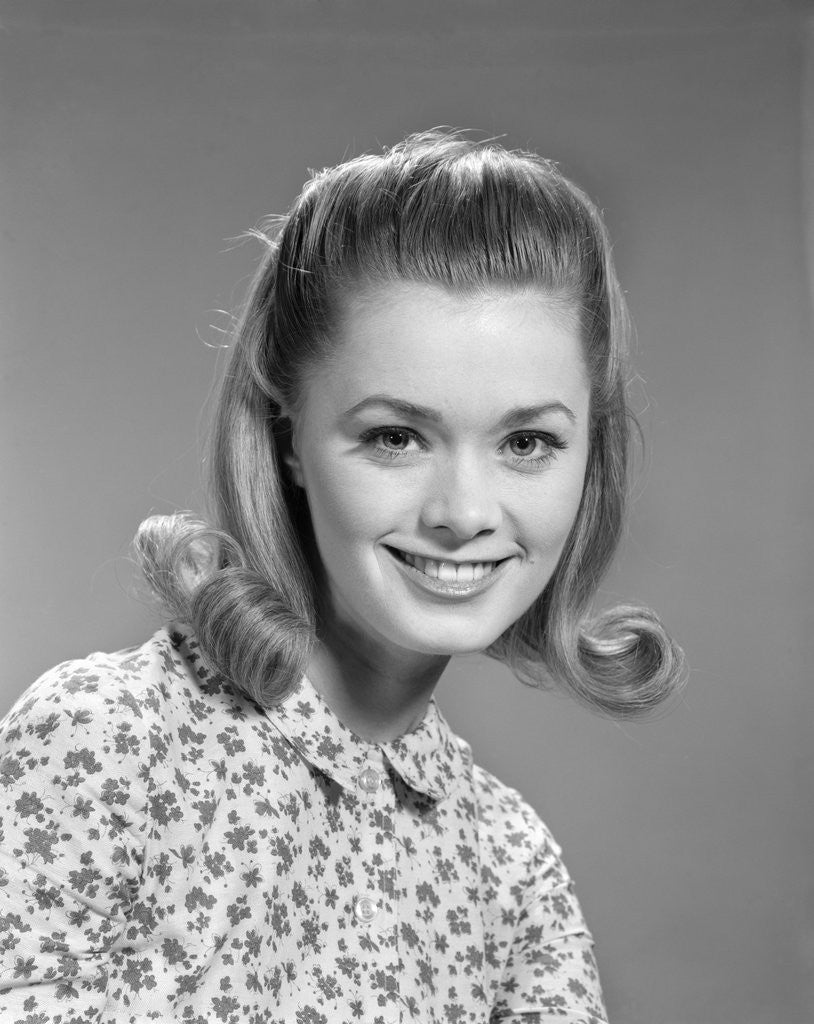 Detail of 1960s portrait smiling woman wearing print blouse with flip hairdo by Anonymous