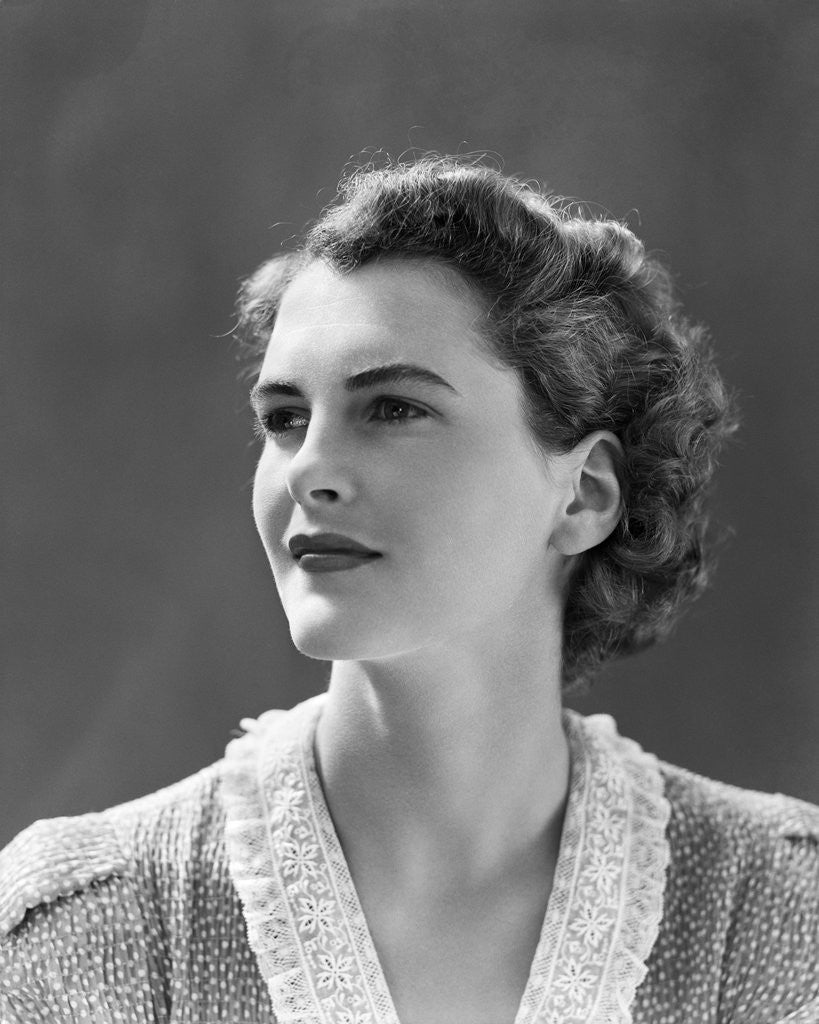 Detail of 1940s profile portrait brunette woman wearing print dress with lace collar by Anonymous