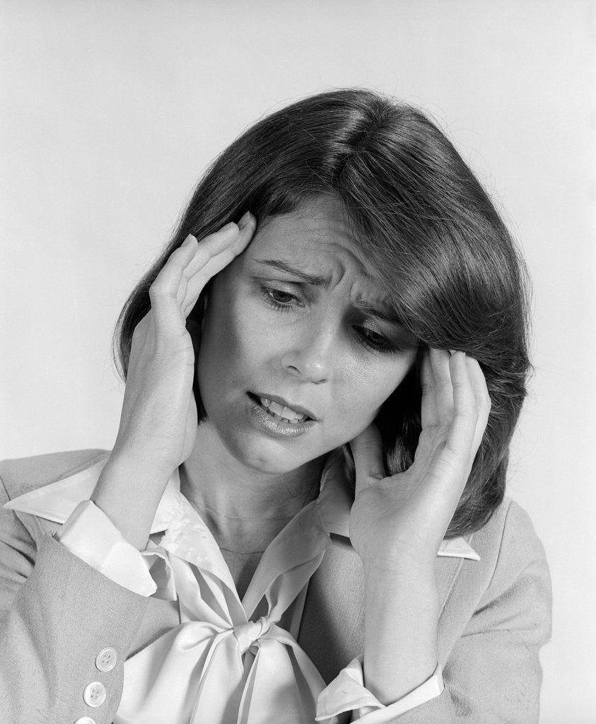 Detail of 1980s portrait woman hands massaging temple forehead headache distress stress by Anonymous