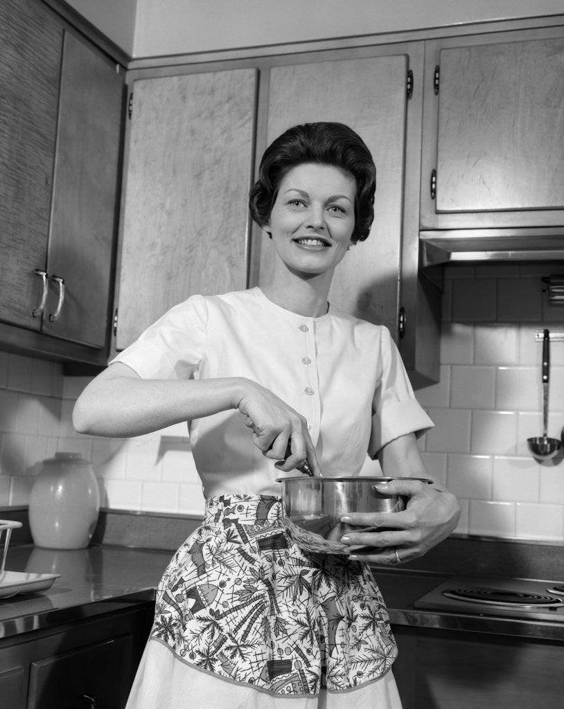 Detail of 1960s woman kitchen housewife stir by Anonymous