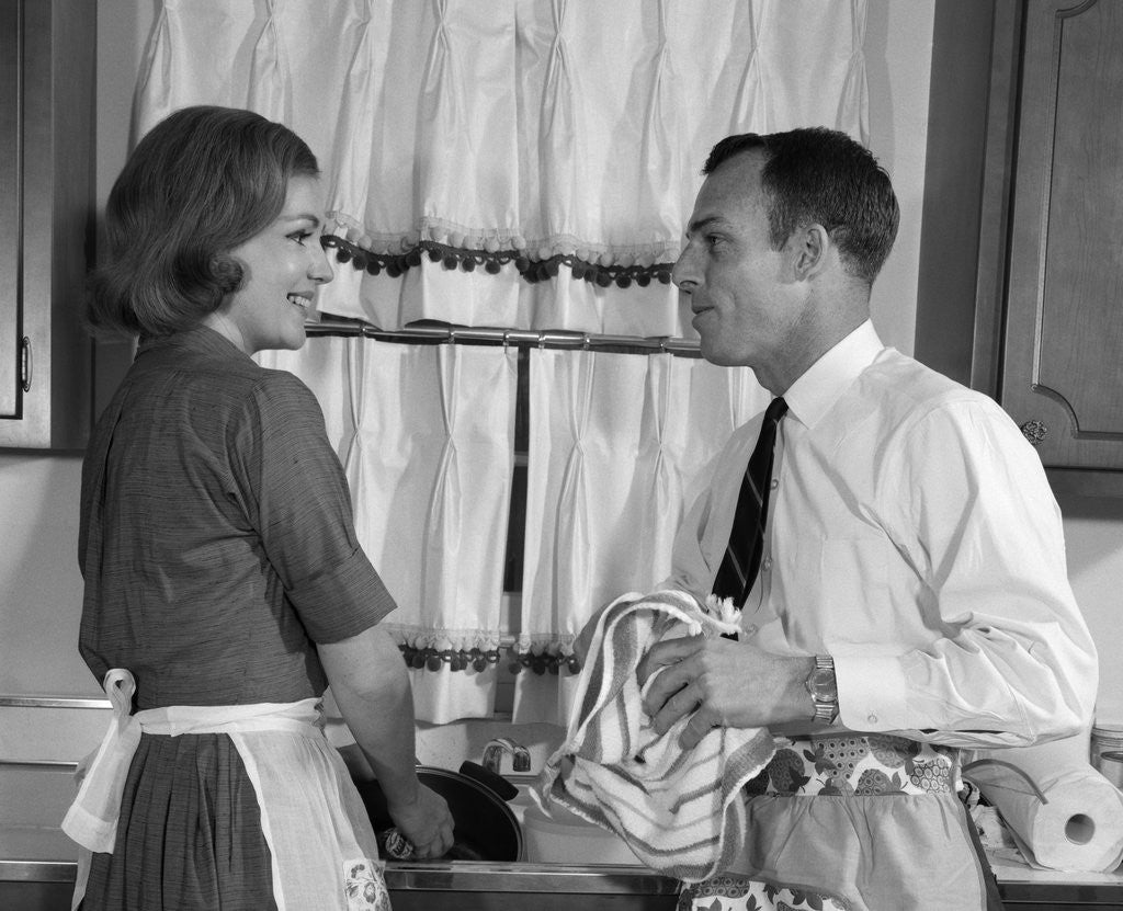 Detail of 1960s man woman washing dishes kitchen sink by Anonymous