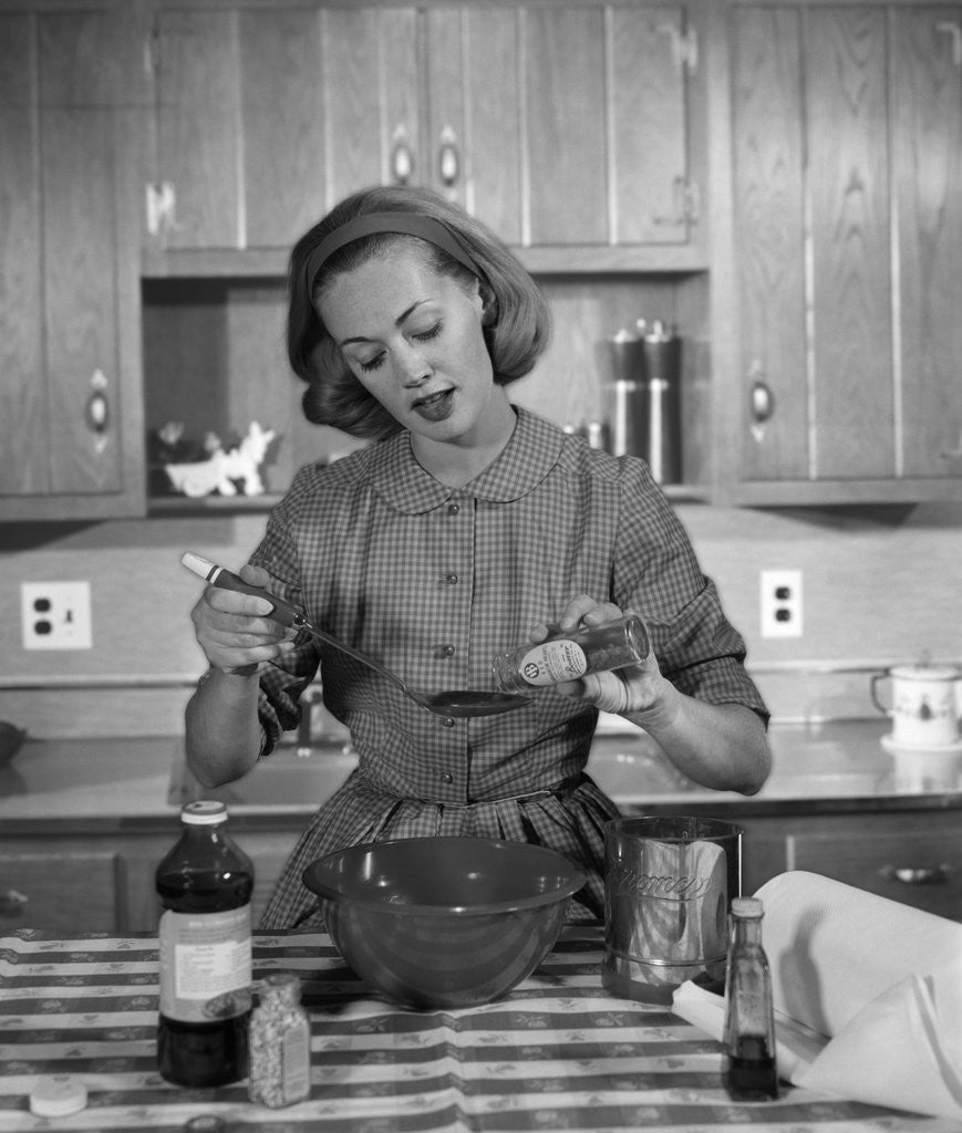 Detail of 1960s woman baking in kitchen by Anonymous