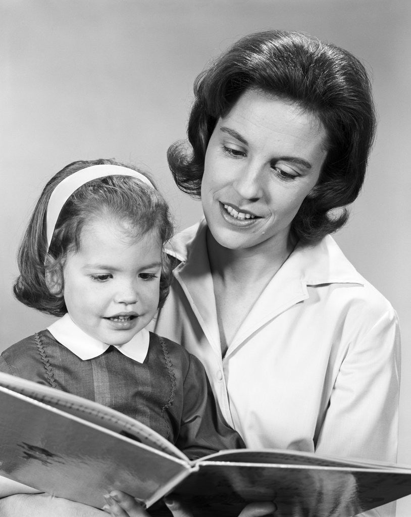 Detail of 1960s woman reading story book to girl child by Anonymous