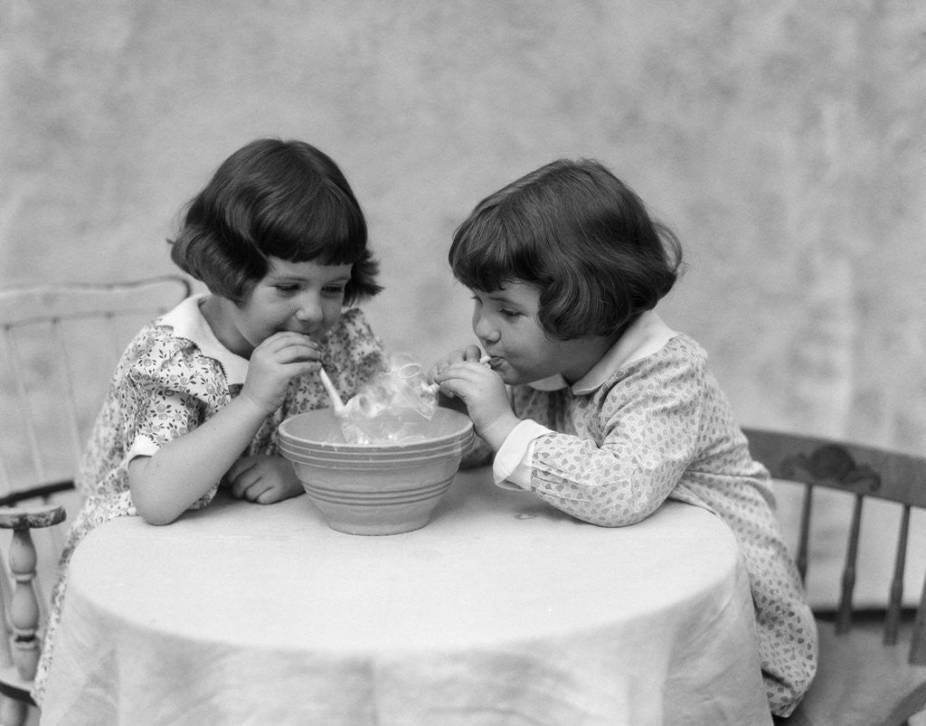 Detail of 1930s two girls playing blowing soap bubble pipes by Anonymous