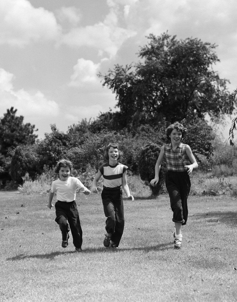 Detail of 1950s three girls running in grassy field by Anonymous
