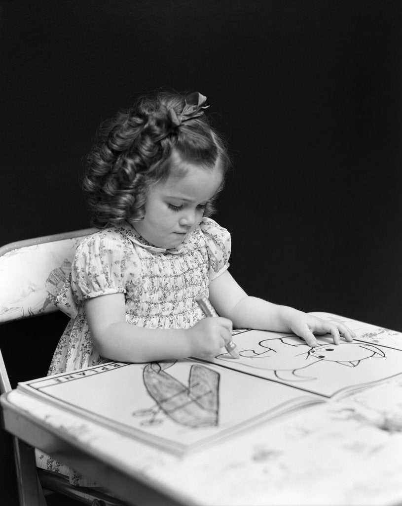 Detail of 1960s 1940s girl child sitting at desk drawing coloring pictures by Anonymous