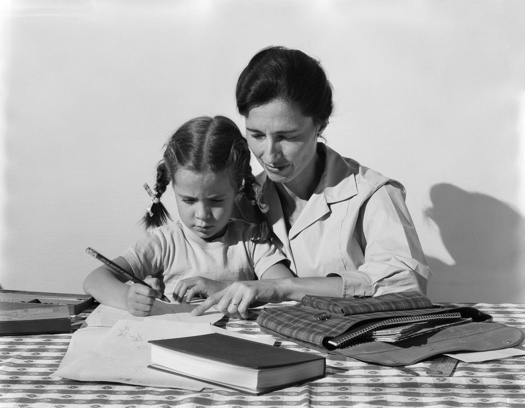 Detail of 1960s child girl doing homework with parent mother by Anonymous