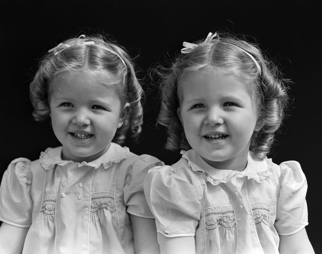 Detail of 1930s portrait twin girls smiling by Anonymous