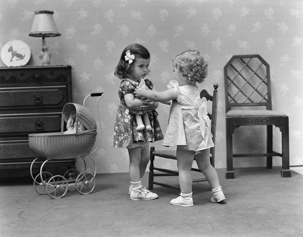 Detail of 1940s two girls playing with dolls by Anonymous